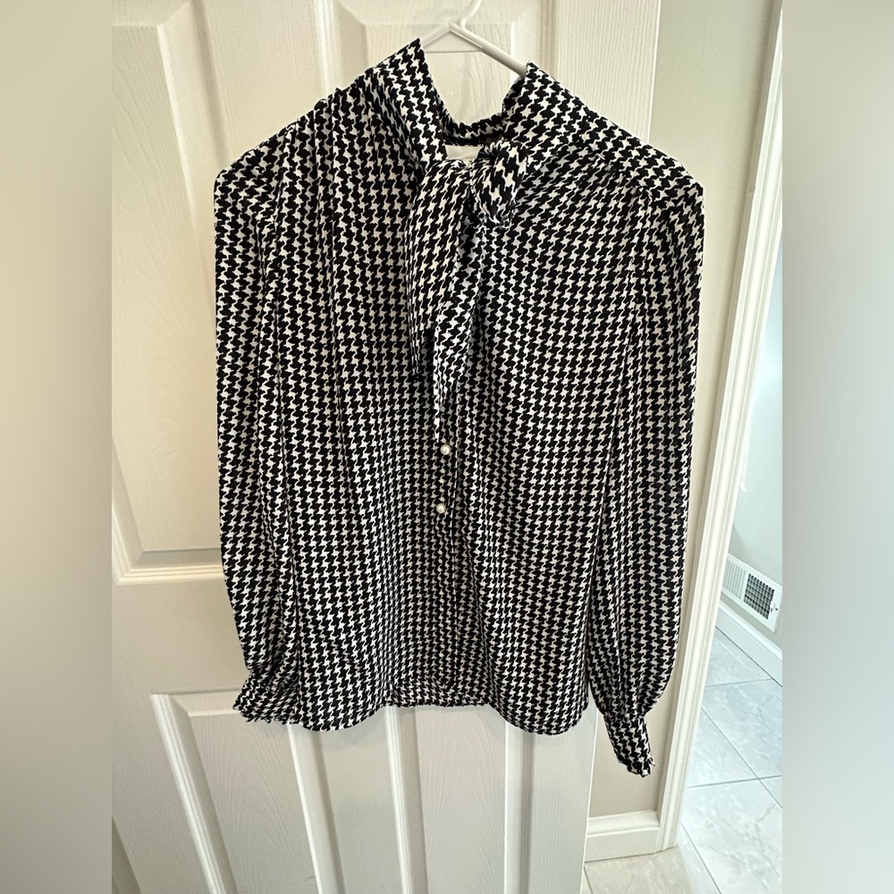 Kate Spade black and white blouse with tie collar and pearl buttons.